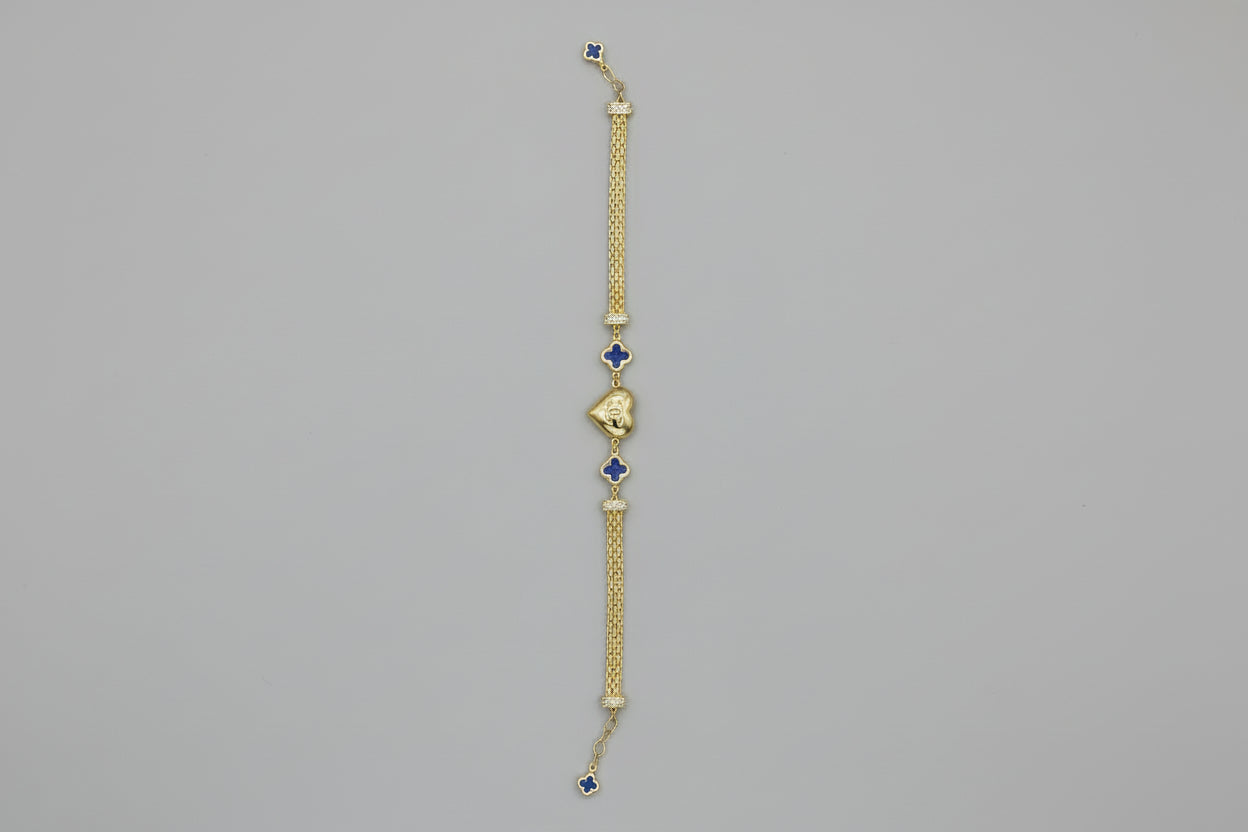 Gold bracelet with blue stones on a gray surface